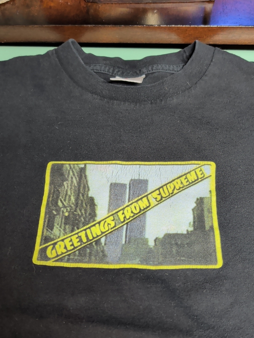 Supreme Black Tee with Yellow 'Greetings From Supreme' Graphic